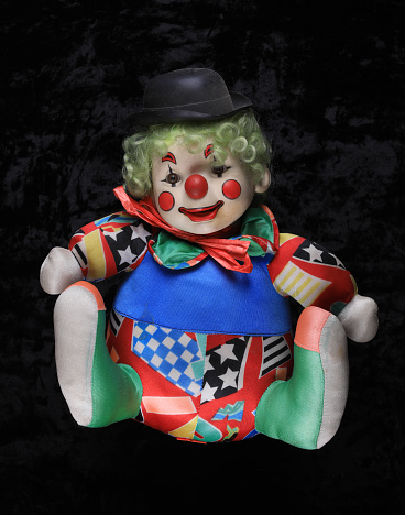 clown doll on a black background