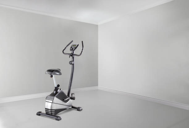 istock Exercise bike in an empty white room 1454684404