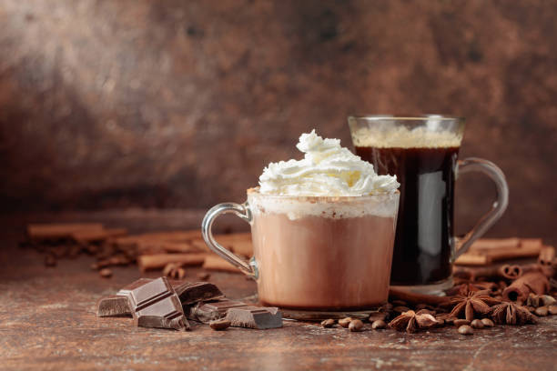 Hot chocolate with whipped cream and black coffee. stock photo