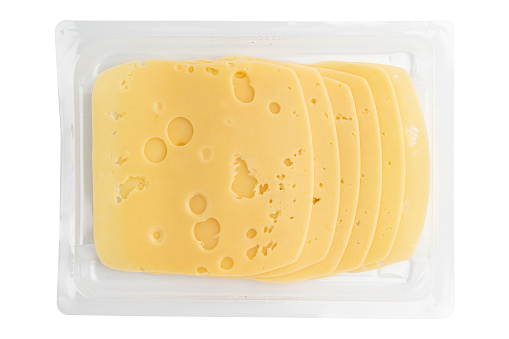 cheese slices isolated on white background, sliced cheese in plastic package, pieces of sliced gouda cheese laid out to create layout