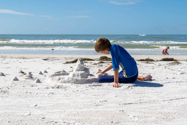 istock Children playing at the beach 1454689260