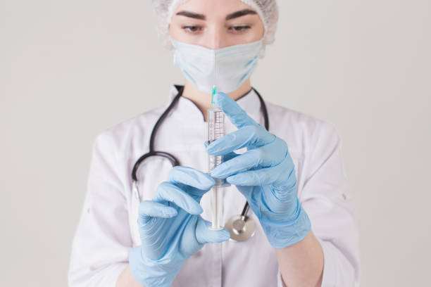 istock Doctor in gloves with syringe 1454694260