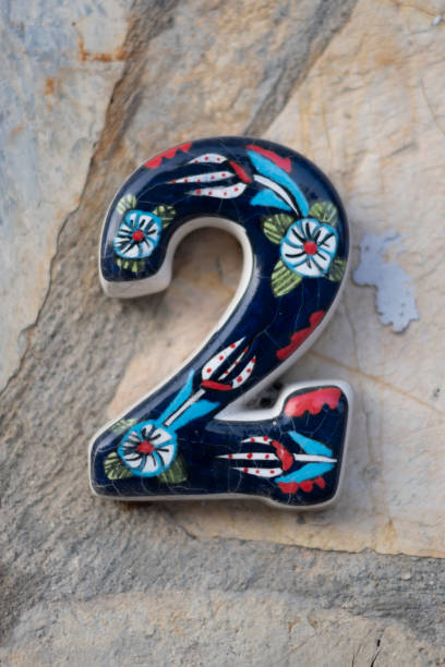 istock Door number hanging on the wall. A 2 shape made of ceramic 1454695199