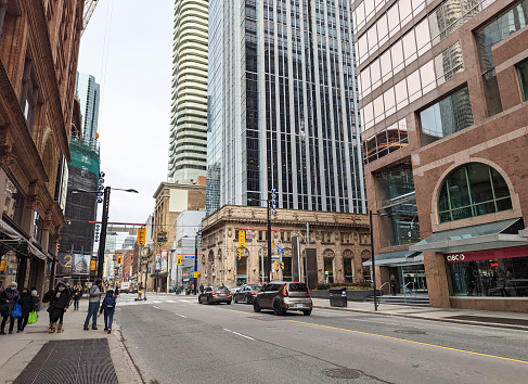 Toronto, Canada - December 5, 2022: Looking north on the 100-block of Yonge Street at Queen Street on an autumn afternoon. Yonge Street extends between the Financial District to the left and west, and the St. Lawrence neighbourhood to the right and east.