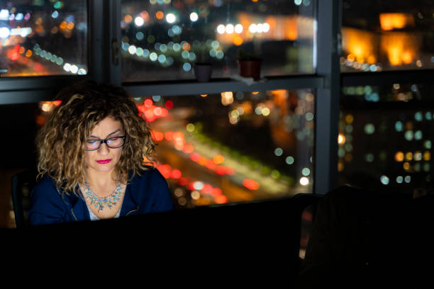istock image of female clerk working evening shift in office 1454699981