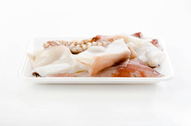 fresh raw squid legs in foam tray