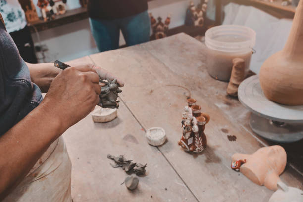 istock Man molding clay to make ceramics with his hands, Artisan working in his workshop, Selective Focus 1454704661