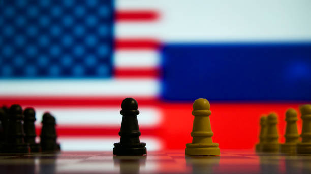 istock Chess pieces in front of the American and Russian flags 1454705652