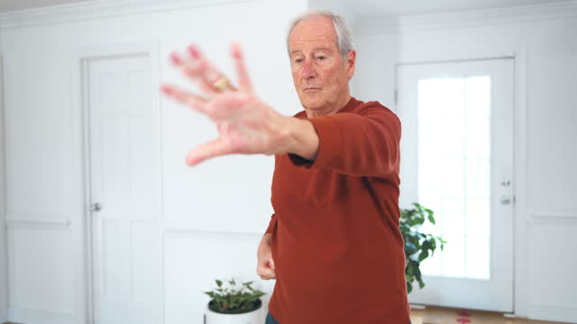 Senior man doing Qi Gong exercises