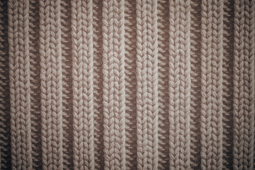 Knit texture of white wool knitted fabric with cable pattern as background
