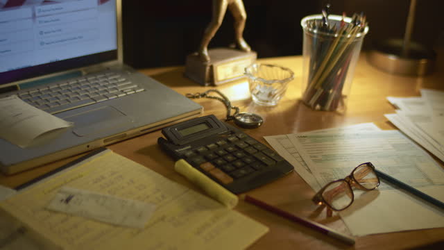 Desk filled with tax forms and tax calculating tools