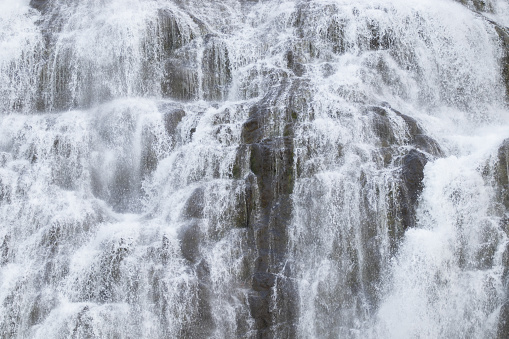 Dynjandi Waterfall Water Texture. Beautiful Pure Nature in Iceland. Powerful Mountain River Background. Huge Water Stream, Infinite Natural Energy. Travel Europe. Go Everywhere.