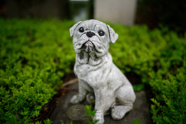 a dog figure bravely guarding a grave in a cemetery