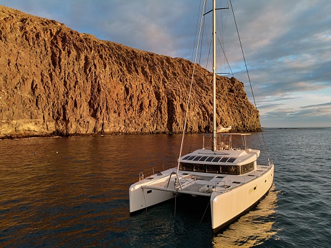 A moored lonely modern catamaran in the calm waters of Atlantic Ocean near Canary Islands, Spain