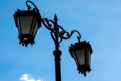 Vintage iron lantern on the street of the modern city