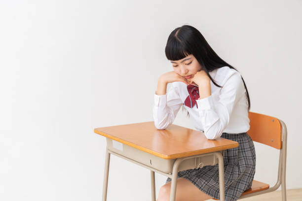 istock girl who study,think,School uniform,School classroom 1454715093