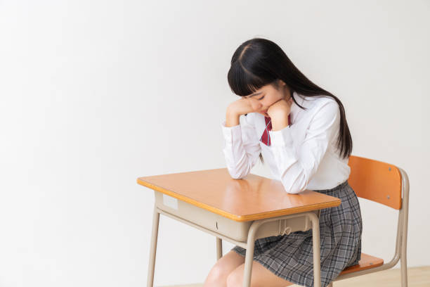 istock girl who study,think,School uniform,School classroom 1454715098