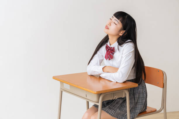istock girl who study,think,School uniform,School classroom 1454715104