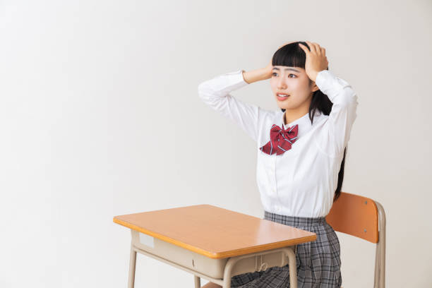istock girl who study,think,School uniform,School classroom 1454715117
