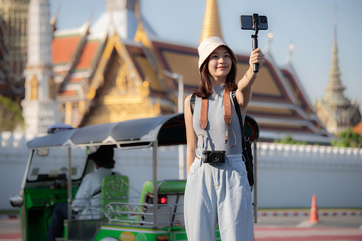 Traveler enjoying a landmark in city. while taking a selfie around
