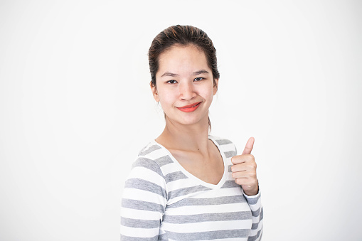 Cheerful woman showing thumbs up gesture