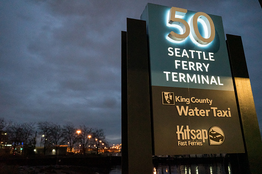 Seattle, USA - Dec 13, 2022: Seattle Ferry Terminal sign on pier 50 early in the evening.