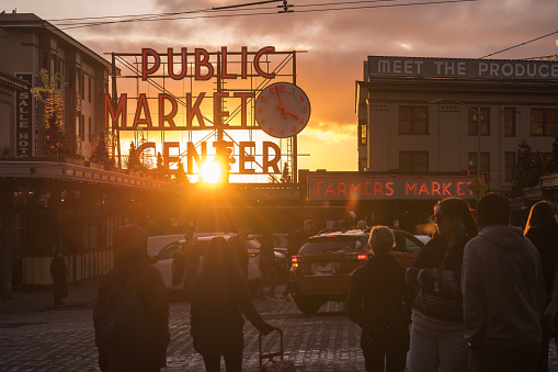 Seattle, USA – Dec 21, 2022: Late in the day the Pike Place Market sign and a vivid sunset just before Christmas.