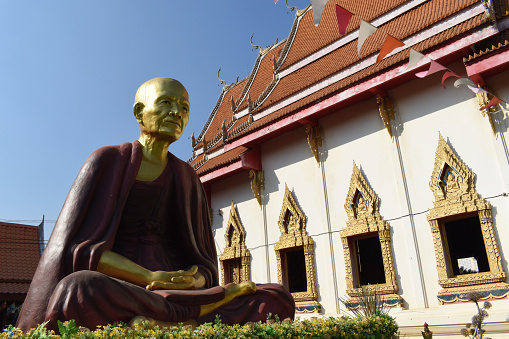 wat sawankha niwet, temple, big statue of praying monk, Phrae, Northwest Thailand, multi-gable temple, snake figures, above the windows buddha reliefs, shutter, much gilded, artwork, crafts, attraction, point of interest