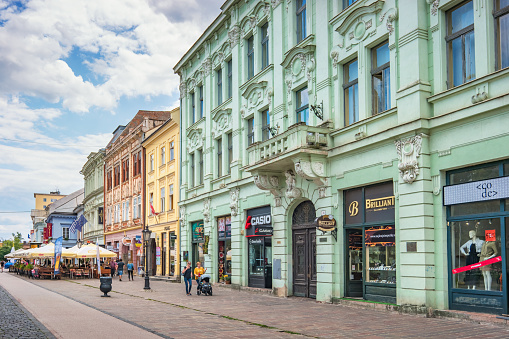 Pedestrians walk past colorful facades in downtown Kosice Slovakia.