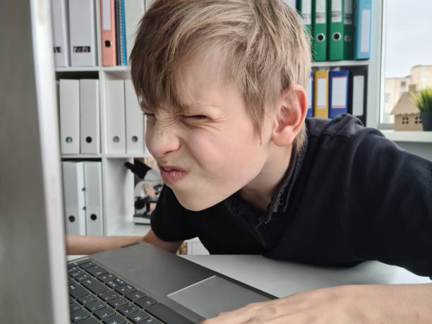 istock Child boy with poor eyesight and laptop 1454721184