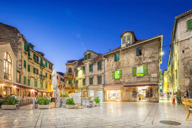 Downtown Split Croatia Night People sit on a restaurant patio in old town Split, Croatia at night. split croatia stock pictures, royalty-free photos & images