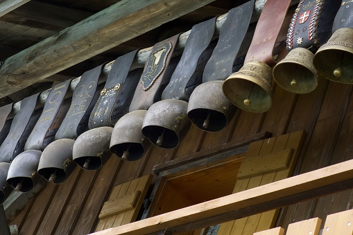 le grand bornand, france - 13 September 2022: a row of traditional alpine cow bells is hanging outside a chalet in the alps