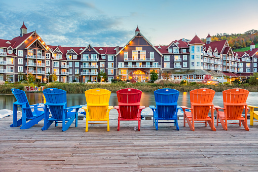 A row of colorful outdoor chairs at the Blue Mountain Village in Collingwood, Ontario, Canada in the evening.