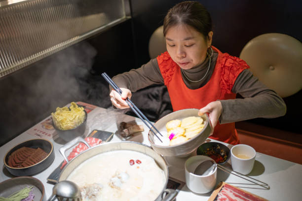 istock woman cooking hot pot 1454726246