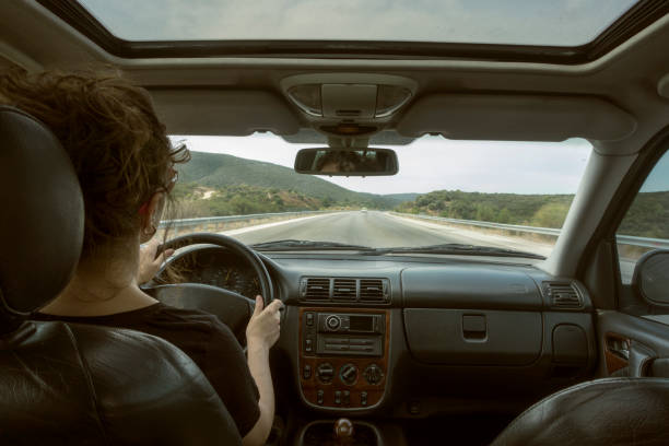 istock female driver driving a car 1454726349