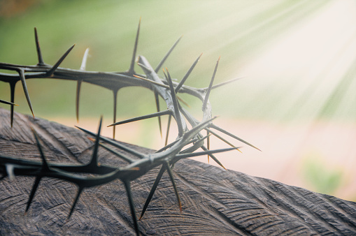 Crucifixion Of Jesus / religion easter background - Crown Of Thorns and rusty old nails in shape of a cross or crucifix, on white marble marble Ground or table or altar