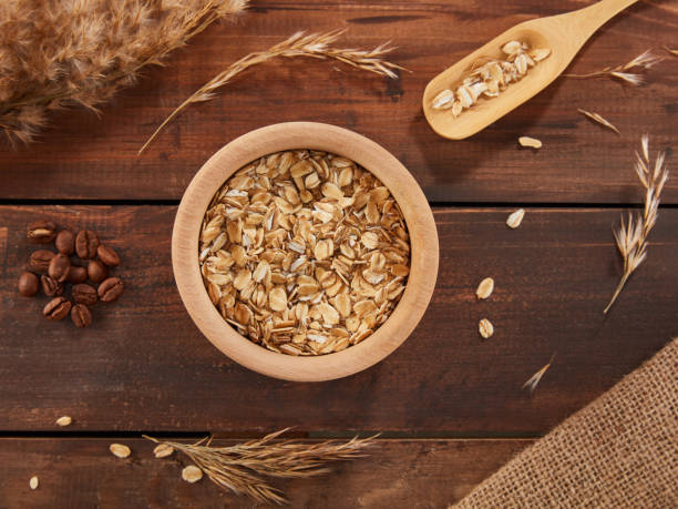istock Oat Flakes in Bowl With Spoon Over Wood Background 1454727614
