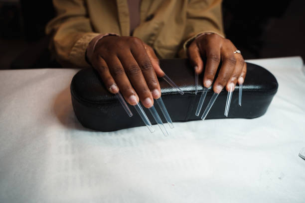 African American women getting an acrylic manicure.