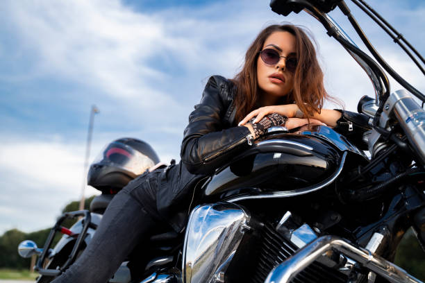 motociclista sensual acostado encima del tanque de gasolina, luciendo coqueto - motorcycle women helmet sensuality fotografías e imágenes de stock