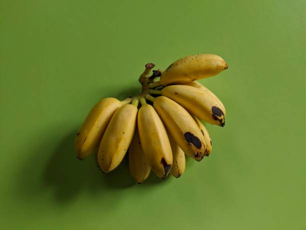 istock Yellow banana fruit on green background 1454733599