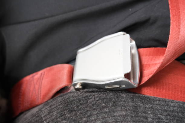 istock Partial view of wearing red seat belt during flight 1454738411