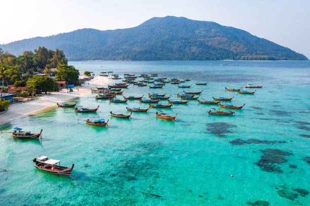 Aerial view of Sunrise beach with long tail boats in Koh Lipe, Satun, Thailand Aerial view of Sunrise beach in Koh Lipe, Satun, Thailand, south east asia satun province stock pictures, royalty-free photos & images