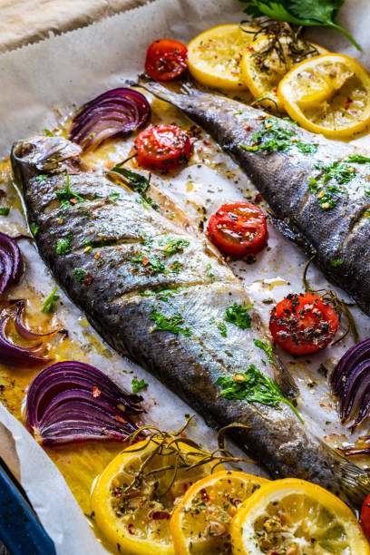One sheet pan trout and vegetables stock photo