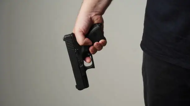 Handgun in gunman hand. A man ready to protect himself from bad people