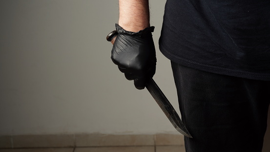 The man with a Combat tactical stainless steel fighting knife in a hand. Closeup Men s hand with a knife.