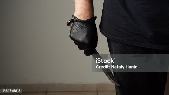 istock The man with a Combat tactical stainless steel fighting knife in a hand. Closeup Men s hand with a knife. 1454745618