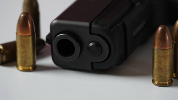 istock Gun with bullets on the white background 1454745647