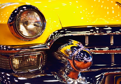a kind of yellow vintage classical american car from 1950s