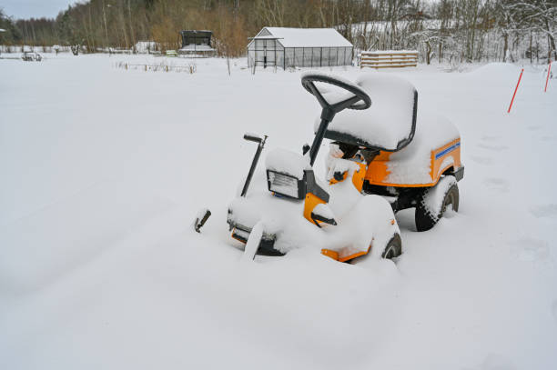 yellow riding lawn mower covered in snow Kumla Sweden january 6 2023