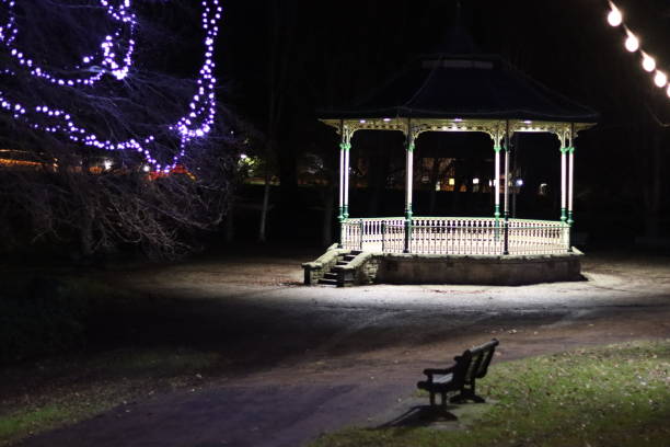 istock Bandstand and trees illuminated at night in a quiet public park 1454759399